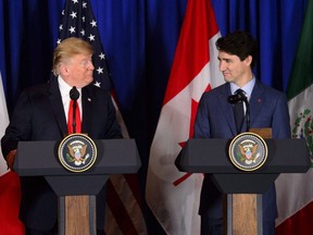 Prime Minister Justin Trudeau, right, and President of the United States Donald Trump participate in a signing ceremony for the new United States-Mexico-Canada Agreement with President of Mexico Enrique Pena Nieto (not shown) in Buenos Aires, Argentina on Friday, Nov. 30, 2018.