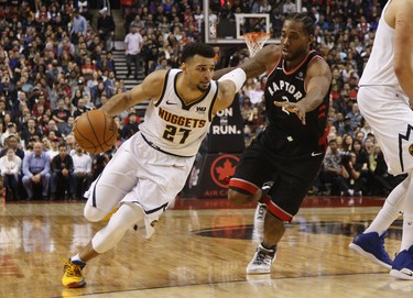 Denver Nuggets Jamal Murray PG (27) goes around Toronto Raptors Kawhi Leonard SF (2) during the fourth quarter in Toronto, Ont. on Monday December 3, 2018. Jack Boland/Toronto Sun/Postmedia Network