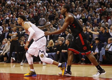 Toronto Raptors Kawhi Leonard SF (2) grabs Denver Nuggets Jamal Murray PG (27) during the fourth quarter in Toronto, Ont. on Monday December 3, 2018. Jack Boland/Toronto Sun/Postmedia Network