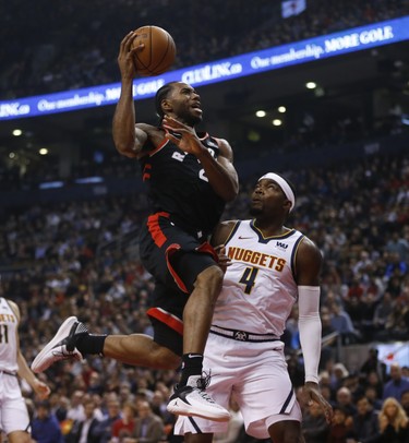 Toronto Raptors Lorenzo Brown PG (4) goes up against Denver Nuggets Paul Millsap PF (4) during the first half in Toronto, Ont. on Tuesday December 4, 2018. Jack Boland/Toronto Sun/Postmedia Network