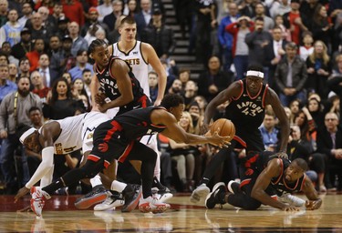 Toronto Raptors Kyle Lowry PG (7) dives for control of a loose ball during the fourth quarter in Toronto, Ont. on Tuesday December 4, 2018. Jack Boland/Toronto Sun/Postmedia Network