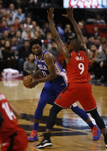 Philadelphia 76ers Joel Embiid C (21) takes a look inside on Toronto Raptors Serge Ibaka PF (9) during the second quarter in Toronto, Ont. on Thursday December 6, 2018. Jack Boland/Toronto Sun/Postmedia Network