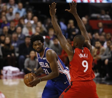 Philadelphia 76ers Joel Embiid C (21) takes a look inside on Toronto Raptors Serge Ibaka PF (9) during the second quarter in Toronto, Ont. on Thursday December 6, 2018. Jack Boland/Toronto Sun/Postmedia Network