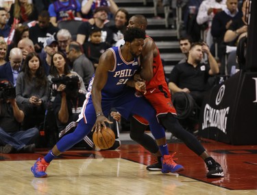 Toronto Raptors Serge Ibaka PF (9)defends against Philadelphia 76ers Joel Embiid C (21) during the third quarter in Toronto, Ont. on Thursday December 6, 2018. Jack Boland/Toronto Sun/Postmedia Network