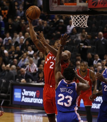 Toronto Raptors Kawhi Leonard SF (2) gets his own big rebound and then scores against Philadelphia 76ers Jimmy Butler SG (23) during the third quarter in Toronto, Ont. on Thursday December 6, 2018. Jack Boland/Toronto Sun/Postmedia Network