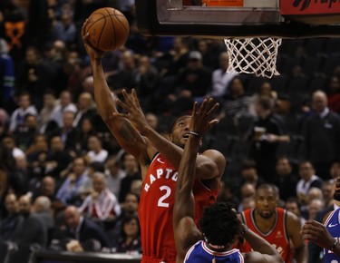 Toronto Raptors Kawhi Leonard SF (2) gets his own big rebound and then scores against Philadelphia 76ers Jimmy Butler SG (23) during the third quarter in Toronto, Ont. on Thursday December 6, 2018. Jack Boland/Toronto Sun/Postmedia Network