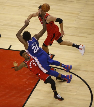 Philadelphia 76ers Joel Embiid C (21) is charged with an offensive foul on Toronto Raptors Kyle Lowry PG (7) during the fourth quarter in Toronto, Ont. on Thursday December 6, 2018. Jack Boland/Toronto Sun/Postmedia Network