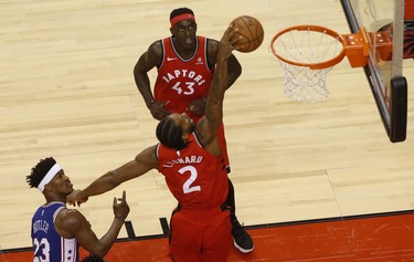 Toronto Raptors Kawhi Leonard SF (2) cuts through past Philadelphia 76ers Jimmy Butler SG (23) for two of his 36 points during the fourth quarter in Toronto, Ont. on Thursday December 6, 2018. Jack Boland/Toronto Sun/Postmedia Network