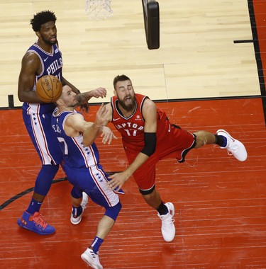 Toronto Raptors Jonas Valanciunas C (17) is fouled by Philadelphia 76ers JJ Redick SG (17)  during the fourth quarter in Toronto, Ont. on Thursday December 6, 2018. Jack Boland/Toronto Sun/Postmedia Network