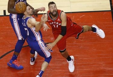 Toronto Raptors Jonas Valanciunas C (17) is fouled by Philadelphia 76ers JJ Redick SG (17)  during the fourth quarter in Toronto, Ont. on Thursday December 6, 2018. Jack Boland/Toronto Sun/Postmedia Network