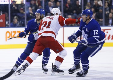 Toronto Maple Leafs William Nylander RW (29) and teammate Patrick Marleau C (12) try to sandwich Detroit Red Wings Dylan Larkin C (71) during the first period in Toronto on Friday December 7, 2018. Jack Boland/Toronto Sun/Postmedia Network