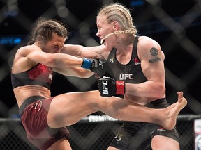 Valentina Shevchenko, right, fights Joanna Jedrzejczyk during the UFC Women’s Flyweight title bout in Toronto on Sunday, Dec. 9, 2018.