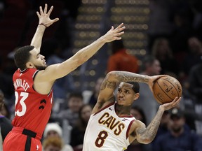 The Raptors' Fred VanVleet (left) guards the Cavaliers' Jordan Clarkson in Cleveland on Saturday night. (Tony Dejak/The Associated Press)