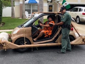 Don Swartz, wearing a Fred Flinstone outfit and driving a stylized
"foot mobile" was pulled over and ticketed for speeding by a Pasco,
Florida officer in November. (Photo from Pasco Sheriff's Office)