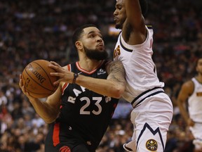 Fred VanVleet's road to the basket is blocked by the Denver Nuggets' Monte Morris during the first half in Toronto on Tuesday night. (Jack Boland/Toronto Sun)