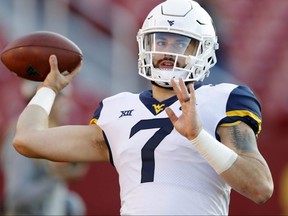 In this Oct. 13, 2018 file photo, West Virginia quarterback Will Grier warms up before a game against Iowa State in Ames, Iowa.