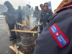 Canada Post workers spend the last hours on the picket line before returning to work after the government ordered them to end their rotating strike Nov. 27, 2018 in Montreal.