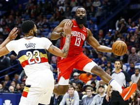 Houston Rockets guard James Harden passes the ball around New Orleans Pelicans' Anthony Davis last week. (AP PHOTO)