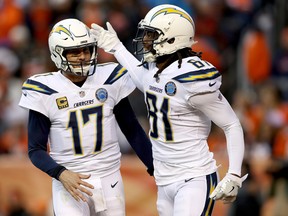 Chargers quarterback Philip Rivers (left) and wide receiver Mike Williams celebrate a touchdown against the Denver Broncos last week. (GETTY IMAGES)