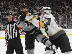 Referee Wes McCauley looks on as Tomas Nosek #92 of the Vegas Golden Knights shoves Jake Muzzin #6 of the Los Angeles Kings in the second period of their game at T-Mobile Arena on December 23, 2018 in Las Vegas, Nevada. (Ethan Miller/Getty Images)
