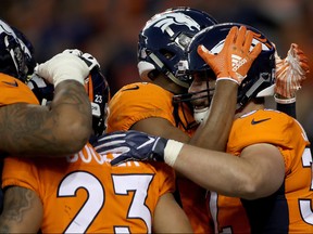 Andy Janovich #32 of the Denver Broncos is congratulated by his teammates after scoring a touchdown against the Los Angeles Chargers at Broncos Stadium at Mile High on Dec. 30, 2018 in Denver, Col. (Matthew Stockman/Getty Images)