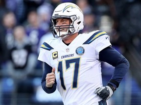 Philip Rivers #17 of the Los Angeles Chargers celebrates after throwing a two point conversion to Mike Williams #81 against the Baltimore Ravens during the fourth quarter in the AFC Wild Card Playoff game at M&T Bank Stadium on January 06, 2019 in Baltimore, Maryland.