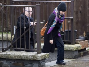Huawei chief financial officer Meng Wanzhou, leaves her home with a security guard in Vancouver on Wednesday, December 12, 2018. THE CANADIAN PRESS/Jonathan Hayward