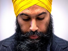 NDP Leader Jagmeet Singh looks at his notes while speaking during the second day of a three-day NDP caucus national strategy session in Surrey, B.C., on Wednesday September 12, 2018. THE CANADIAN PRESS/Darryl Dyck ORG XMIT: VCRD107