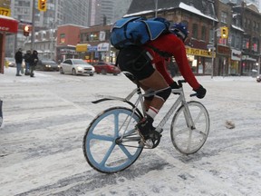 Bike courier Dennis braved Monday's winter storm in shorts. (Jack Boland, Toronto Sun)