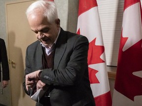 John McCallum, ambassador to China, checks his watch as he arrives for a cabinet meeting in Sherbrooke, Que.,  on Jan. 16, 2019. (The Canadian Press)