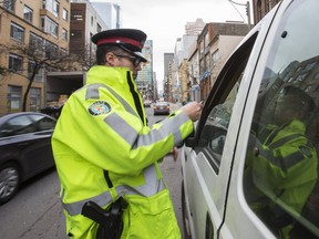 Const. Bryan Brett pulls over a driver who was holding a his phone in his hand using it as a GPS along Richmond St. E., on the first day of a Distracted Driving campaign in Toronto, Ont. on Monday January 14, 2019. (Ernest Doroszuk/Toronto Sun/Postmedia)