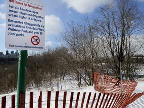 The sign and fence at the Riverdale Park tobaggan hill. (Veronica Henri, Toronto Sun)