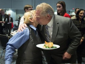 Server Elena Huskisson gets a hug and a kiss from Premier Doug Ford after he speaks to the Economic Club of Canada on Jan. 21, 2019. (Stan Behal, Toronto Sun)