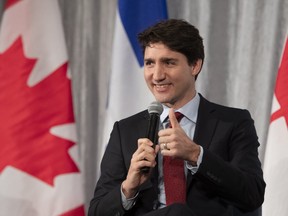 Prime Minister Justin Trudeau gives the thumbs up after he was given a microphone that worked, at a chamber of commerce luncheon  in Quebec City on Friday, Jan. 25, 2019. (THE CANADIAN PRESS/Jacques Boissinot)