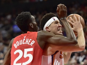 Phoenix Suns guard Devin Booker drives to the basket past Raptors forward Chris Boucher on Thursday night. (THE CANADIAN PRESS)