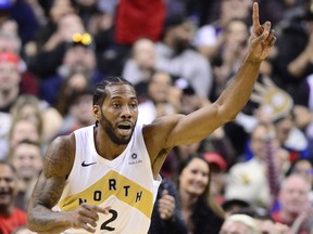 Toronto Raptors forward Kawhi Leonard celebrates after making an off-balance basket against the Brooklyn Nets last week. (THE CANADIAN PRESS)