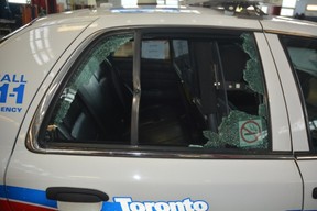 The rear window of the Toronto Police cruiser which shattered when it was struck by a police bullet during the Danforth shooting. A projectile was found lodged in the bent portion of the frame.