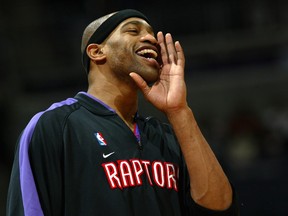Vince Carter #15 of the Toronto Raptors fires up his teammates during pre-game warm ups as they prepare to face the Washington Wizards during NBA action on March 3, 2004 at the MCI Center in Washington, DC.   (Photo by Doug Pensinger/Getty Images)