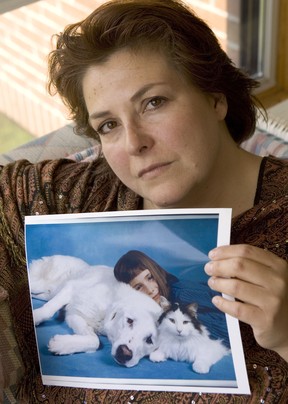 Sunny Reuter poses with a photo of her now-deceased dog Arko. The dog was killed by the OSPCA in 2003 while Reuter was on vacation.