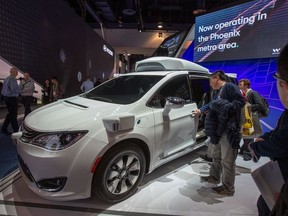 People look at the Waymo car, formerly the Google self-driving car project, during the Las Vegas Convention Center during CES 2019 in Las Vegas on January 9, 2019.