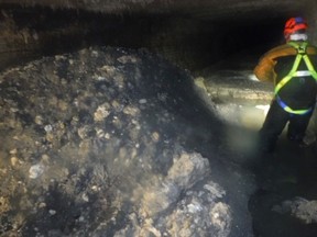 In this photo released Tuesday Jan. 8, 2019, by Britain's South West Water company, showing part of a "fatberg", a mass of hardened fat, oil and baby wipes, measuring some 64 meters (210 feet) long, in the town of Sidmouth, England.  The fatberg is blocking a sewer in the southwestern English town, and will take a sewer team around eight weeks to dissect and dispose of the obstruction. (South West Water via AP) ORG XMIT: LON817
