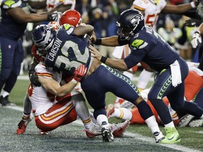 Running back Chris Carson (centre), quarterback Russell Wilson (right) and the Seattle Seahawks went 6-1 after starting the season at 4-5 to make this year’s playoffs. They face the Cowboys on Saturday night. (AP)