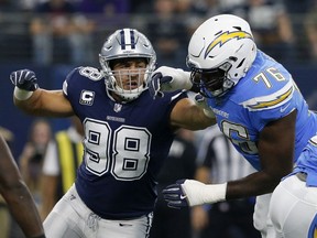 In this Nov. 23, 2017, file photo, Dallas Cowboys defensive end Tyrone Crawford (98) faces off against Los Angeles Chargers offensive tackle Russell Okung (76) during an NFL football game in Arlington, Texas.