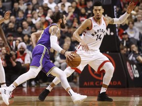 Raptors' Danny Green (14) defends Jazz guard Ricky Rubio (3) during second half NBA action in Toronto, Tuesday, Jan. 1, 2019.