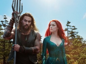 This image released by Warner Bros. Pictures shows Jason Momoa, left, and Amber Heard in a scene from “Aquaman.” (Warner Bros. Pictures via AP)