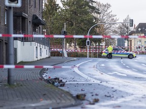Police block a road in Bottrop, Germany, Tuesday, Jan. 1, 2019. (Marcel Kusch/dpa via AP)