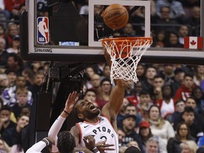 Raptors' Kawhi Leonard goes up to the basket and is fouled by Jae Crowder of the Utah Jazz during the first quarter  in Toronto, Ont., on Tuesday, January 1, 2019. (JACK BOLAND/TORONTO SUN)