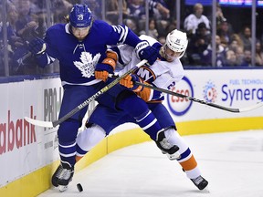 Toronto Maple Leafs right wing William Nylander (29) battles with New York Islanders defenceman Devon Toews (25) in Toronto on Saturday, December 29, 2018. (THE CANADIAN PRESS/Frank Gunn)