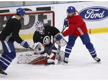 Toronto Maple Leafs Michael Hutchinson G (30) makes a save on teammate John Tavares C (91) during practice at the MCC in Toronto on Friday January 11, 2019. Jack Boland/Toronto Sun/Postmedia Network