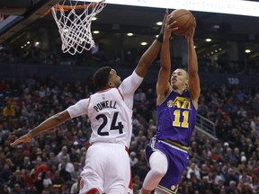 Utah Jazz Dante Exum PG (11) drops in two points against Toronto Raptors Norman Powell SF (24) during the first quarter  in Toronto, Ont. on Tuesday January 1, 2019. Jack Boland/Toronto Sun